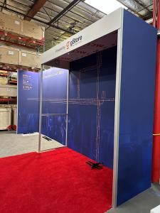 RENTAL: Custom Inline Design with 234" Wide x 118.75" High Gravitee Backwall, S44 Extrusion Return Frame Supporting Ceiling and Header Structure, (4) Monitor Mounts,(5) LED Arm Lights, 75" Monitor, (2) 43" Monitors, SEG Fabric Graphics, and Direct Print S